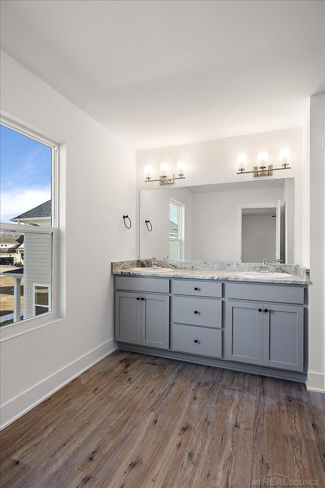 1718 W 12 Mile Rd, Royal Oak, MI 48073 - full bathroom with double vanity, wood finished floors, and plenty of natural light