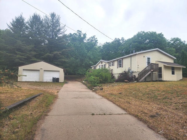 811 N Old State Ave, Harrison, MI 48625 - view of side of property with an outdoor structure and a detached garage