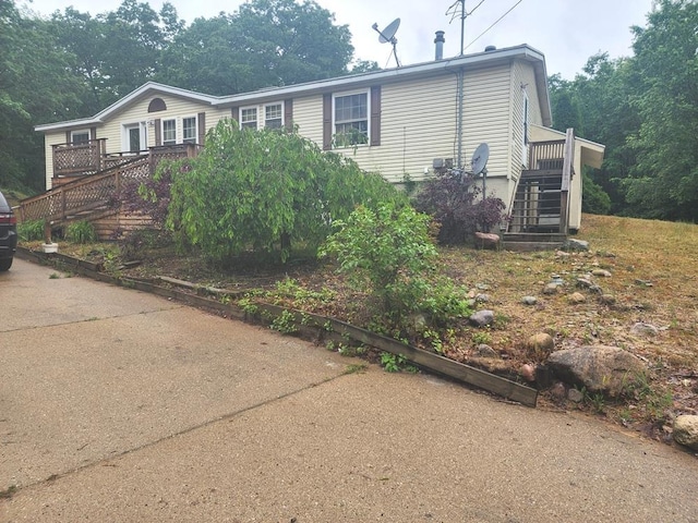 811 N Old State Ave, Harrison, MI 48625 - view of front facade featuring stairway and a wooden deck