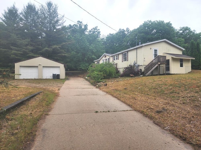 811 N Old State Ave, Harrison, MI 48625 - view of side of property with an outbuilding, a garage, and stairway