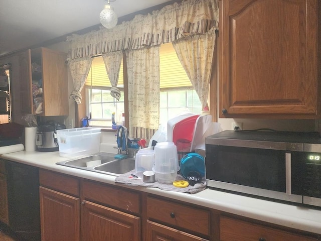 811 N Old State Ave, Harrison, MI 48625 - kitchen with stainless steel microwave, light countertops, and brown cabinets