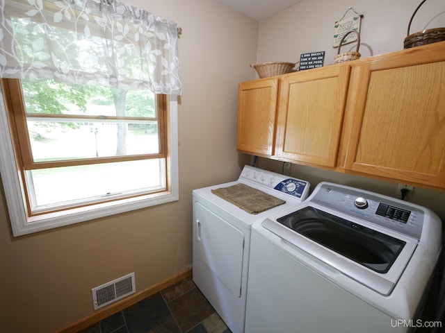 2004 Hunters Ln, Houghton, MI 49931 - laundry area with cabinet space, washing machine and dryer, and dark stone finish floors