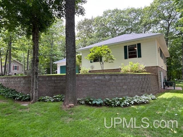 2004 Hunters Ln, Houghton, MI 49931 - view of property exterior featuring a lawn