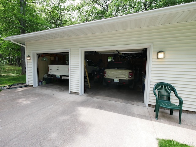 2004 Hunters Ln, Houghton, MI 49931 - garage featuring concrete driveway
