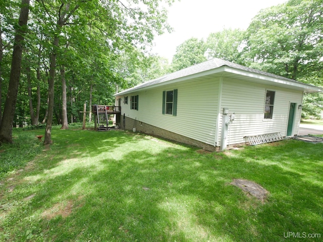 2004 Hunters Ln, Houghton, MI 49931 - view of side of home with a lawn, a deck, and stairs