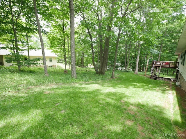 2004 Hunters Ln, Houghton, MI 49931 - view of green lawn featuring a wooden deck and stairs