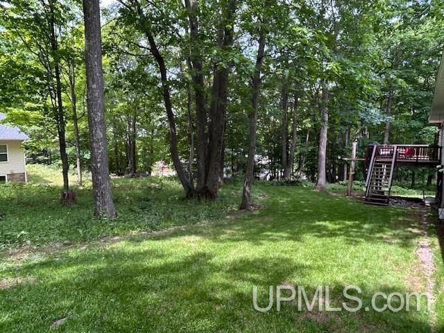 2004 Hunters Ln, Houghton, MI 49931 - view of grassy yard featuring stairway and a deck
