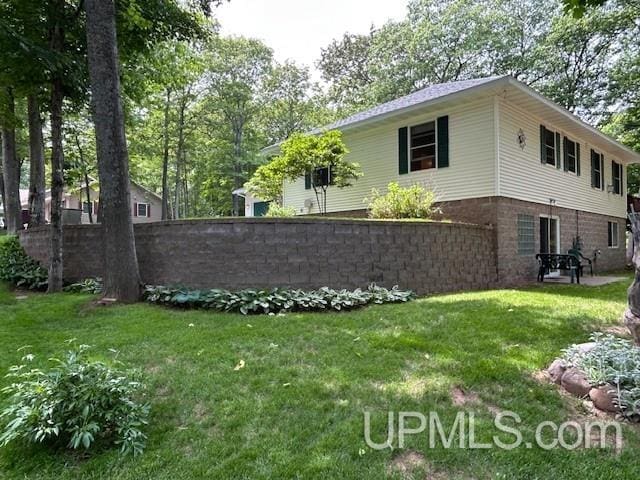 2004 Hunters Ln, Houghton, MI 49931 - view of property exterior featuring a lawn