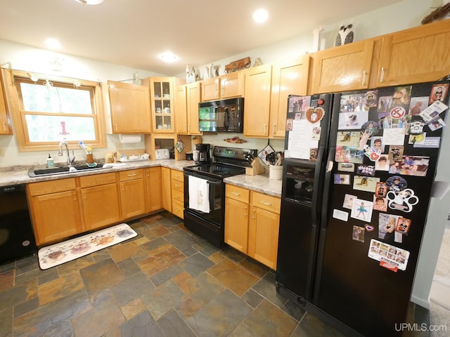 2004 Hunters Ln, Houghton, MI 49931 - kitchen featuring black appliances, dark stone finish floors, glass insert cabinets, light stone countertops, and light brown cabinetry