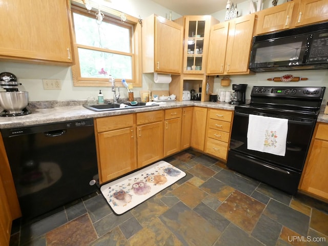 2004 Hunters Ln, Houghton, MI 49931 - kitchen featuring black appliances, stone tile floors, glass insert cabinets, light countertops, and light brown cabinetry