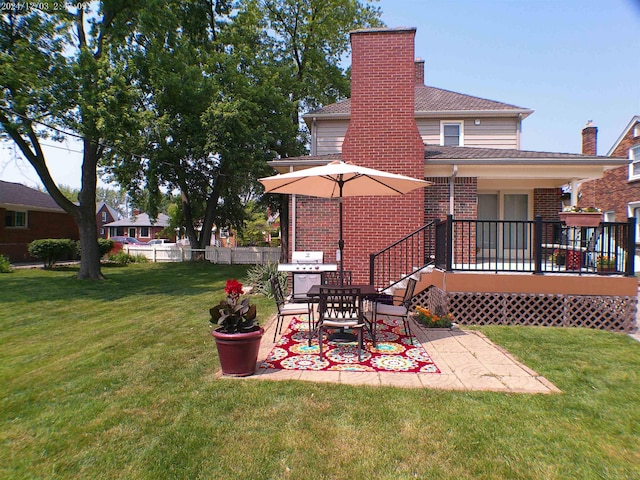15553 Mclain Ave, Allen Park, MI 48101 - back of house with a patio area, brick siding, a chimney, and a wooden deck
