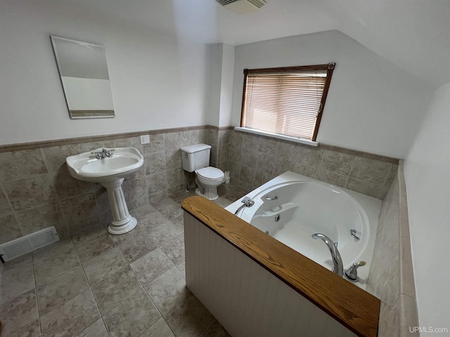 209 N 10th St, Escanaba, MI 49829 - full bathroom with a whirlpool tub, wainscoting, and tile walls