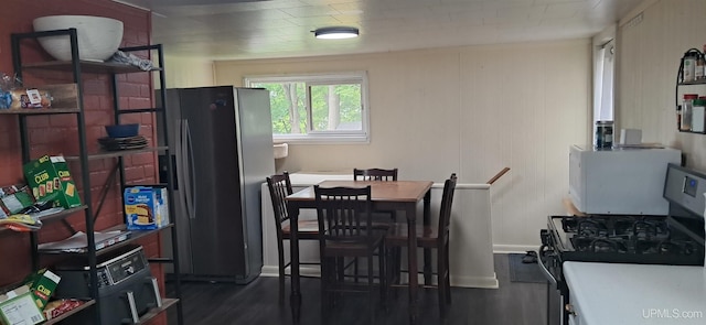309 Fir St, Munising, MI 49862 - dining space with dark wood-type flooring and baseboards