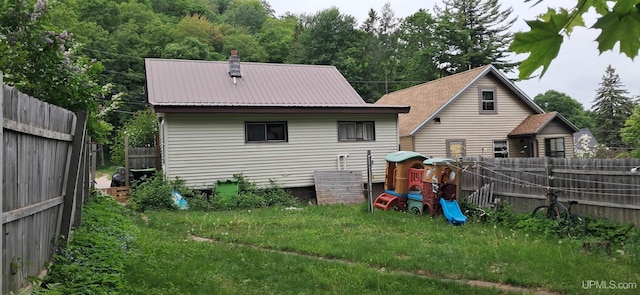 309 Fir St, Munising, MI 49862 - rear view of property with a fenced backyard and a metal roof