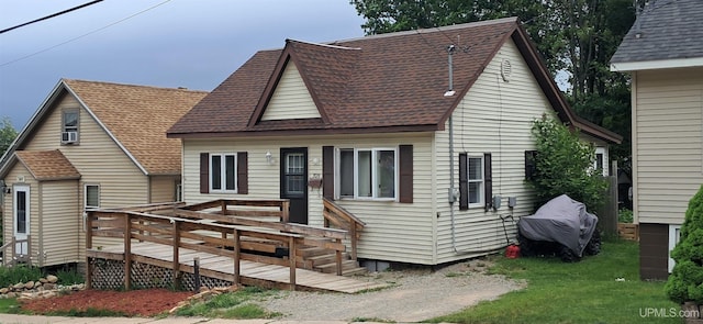 309 Fir St, Munising, MI 49862 - view of front of property featuring roof with shingles, a deck, cooling unit, and a front yard