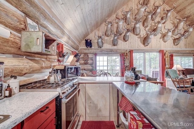 14038 24.5 Ln, Rapid River, MI 49878 - kitchen with stainless steel appliances, stainless steel counters, log walls, vaulted ceiling, and plenty of natural light
