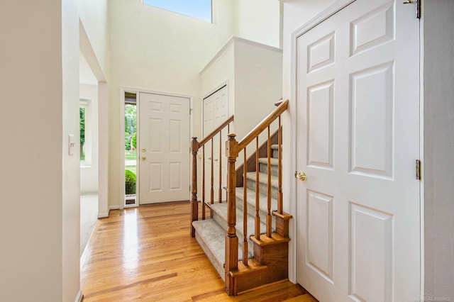 24781 Camille St, Harrison Twp, MI 48045 - entryway with light wood finished floors, stairs, and a towering ceiling
