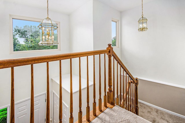 24781 Camille St, Harrison Twp, MI 48045 - stairway featuring a chandelier, plenty of natural light, and carpet flooring