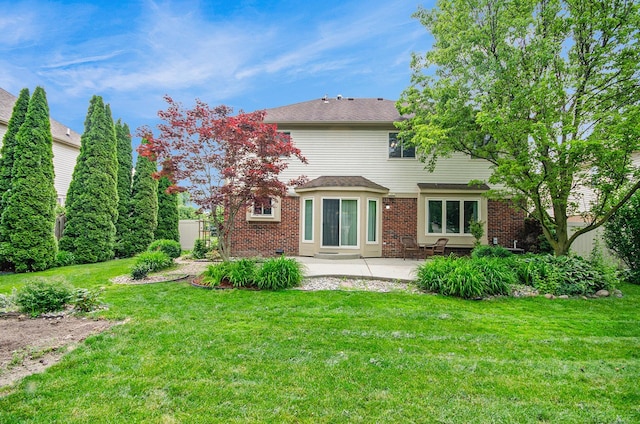 24781 Camille St, Harrison Twp, MI 48045 - back of house with a patio, brick siding, and a yard