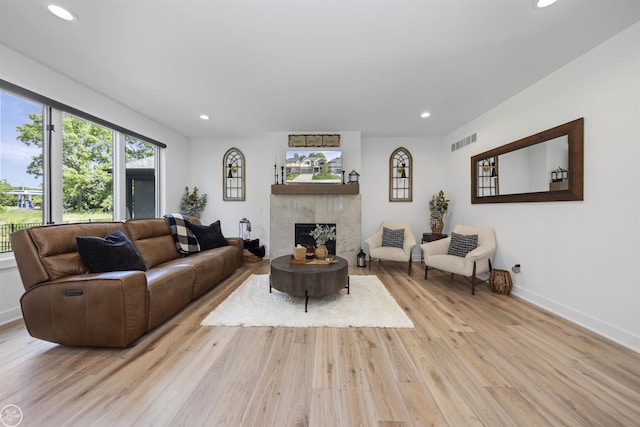 54877 Camden Ct, Shelby Twp, MI 48316 - living room with recessed lighting, light wood-style floors, and a fireplace