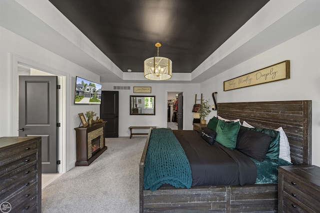54877 Camden Ct, Shelby Twp, MI 48316 - carpeted bedroom with a chandelier, a walk in closet, and a raised ceiling