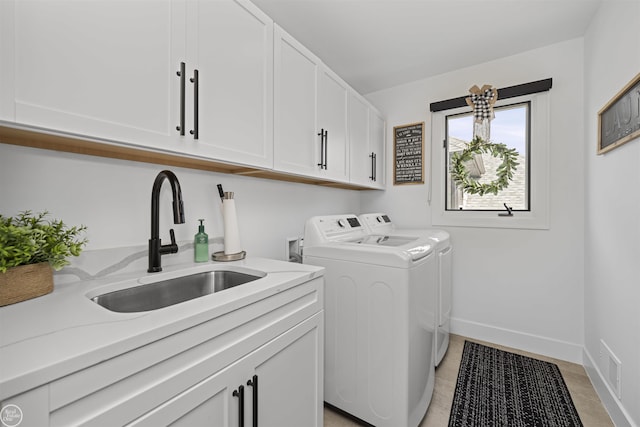 54877 Camden Ct, Shelby Twp, MI 48316 - laundry area with cabinet space, independent washer and dryer, and light tile patterned floors