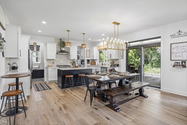 54877 Camden Ct, Shelby Twp, MI 48316 - dining space featuring light wood-style flooring, recessed lighting, and plenty of natural light