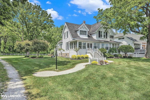 1520 S Channel Dr, Harsens Island, MI 48028 - rear view of property with a sunroom, a chimney, and roof with shingles