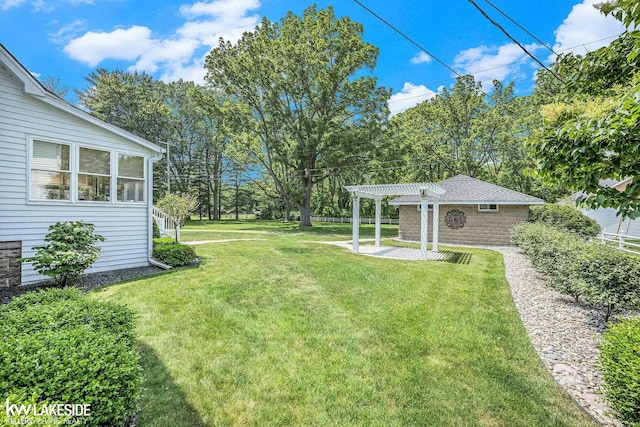 1520 S Channel Dr, Harsens Island, MI 48028 - view of grassy yard featuring a pergola, an outdoor structure, a patio area, and view of wooded area