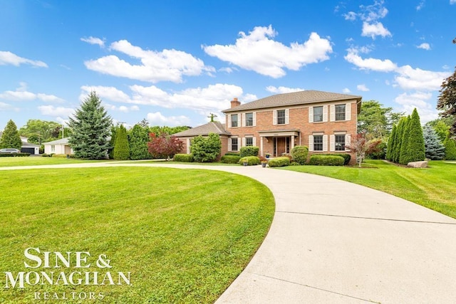 1001 Lake Shore Rd, Grosse Pointe Shores, MI 48236 - view of front of house featuring curved driveway, a front lawn, a chimney, and brick siding