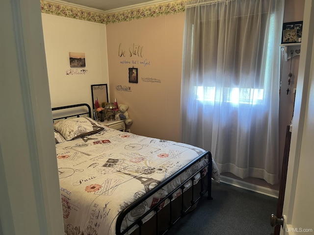 754 Duncan Ave, Ishpeming, MI 49849 - bedroom featuring dark carpet and crown molding