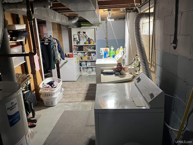 754 Duncan Ave, Ishpeming, MI 49849 - unfinished below grade area with independent washer and dryer, fridge, and concrete block wall