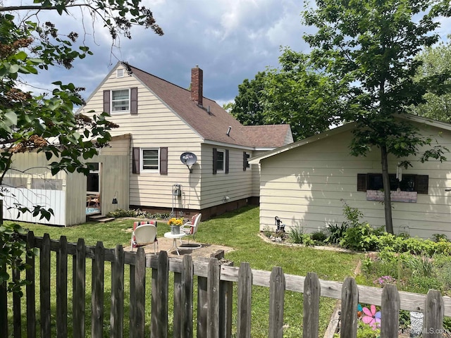 754 Duncan Ave, Ishpeming, MI 49849 - back of house featuring a chimney and roof with shingles