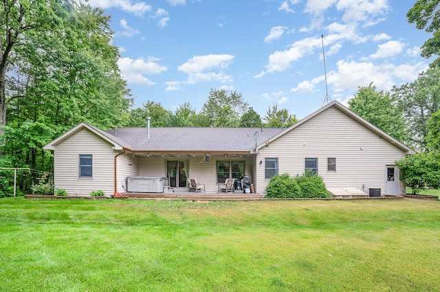 6242 N Geneva Rd, Coleman, MI 48618 - back of house featuring a hot tub, a lawn, a patio, and roof with shingles