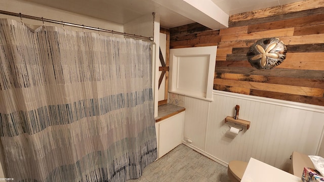 4467 Kings Corner Rd, Glennie, MI 48737 - bathroom with wooden walls and a shower with shower curtain