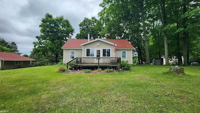 4467 Kings Corner Rd, Glennie, MI 48737 - back of house with a deck, a yard, and a storage unit