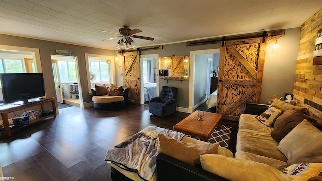 4467 Kings Corner Rd, Glennie, MI 48737 - living area with a barn door, dark wood finished floors, and ceiling fan