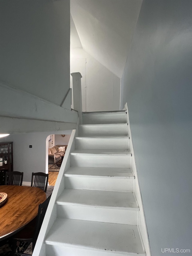 206 Cherry St, Munising, MI 49862 - stairway featuring vaulted ceiling
