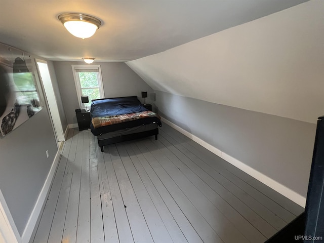 206 Cherry St, Munising, MI 49862 - bedroom featuring hardwood / wood-style floors and vaulted ceiling