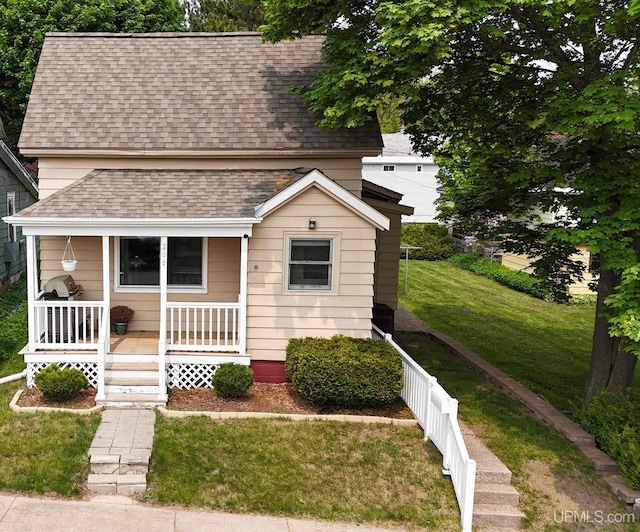 206 Cherry St, Munising, MI 49862 - view of front facade with a shingled roof and a porch