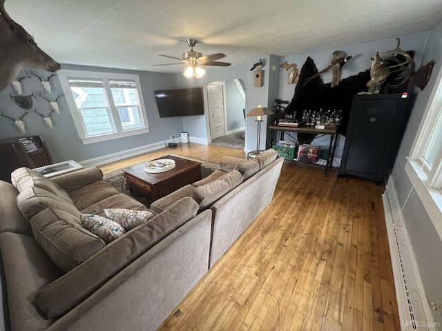 206 Cherry St, Munising, MI 49862 - living area with ceiling fan, hardwood / wood-style flooring, and a baseboard heating unit