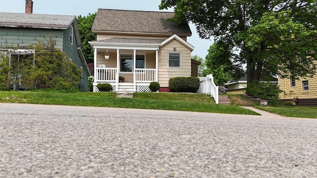 206 Cherry St, Munising, MI 49862 - bungalow with a porch and roof with shingles