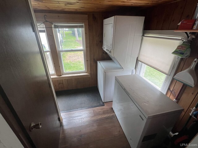 206 Cherry St, Munising, MI 49862 - laundry area with wooden ceiling, stacked washer / dryer, wood finished floors, and wood walls