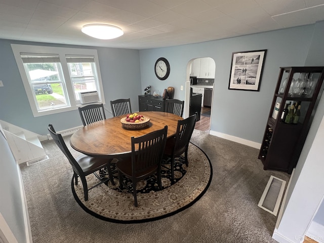 206 Cherry St, Munising, MI 49862 - dining room with dark carpet, arched walkways, and cooling unit