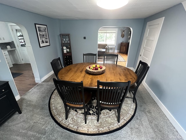 206 Cherry St, Munising, MI 49862 - dining room with arched walkways and dark colored carpet