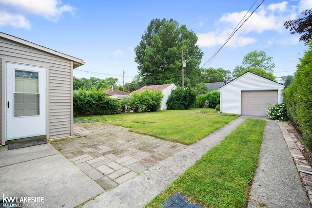 3620 Campbell St, Dearborn, MI 48124 - view of green lawn featuring an outbuilding, a detached garage, and driveway