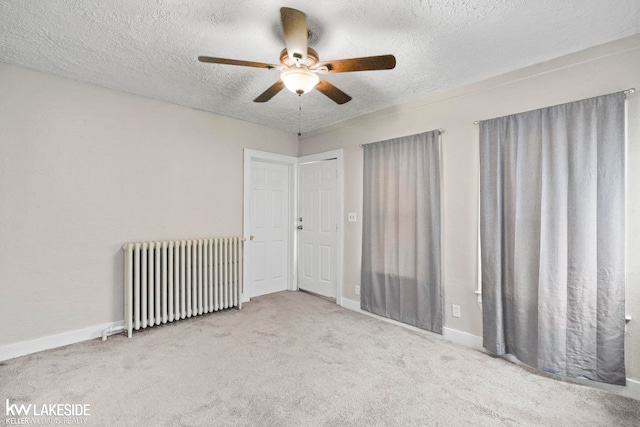 3620 Campbell St, Dearborn, MI 48124 - carpeted empty room featuring radiator heating unit, a ceiling fan, and a textured ceiling