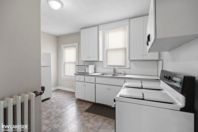 3620 Campbell St, Dearborn, MI 48124 - kitchen featuring white appliances, radiator heating unit, white cabinetry, a textured ceiling, and light countertops