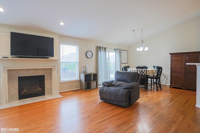56798 Winding Creek Dr, Macomb, MI 48042 - living area with wood-type flooring, a chandelier, lofted ceiling, a fireplace, and recessed lighting