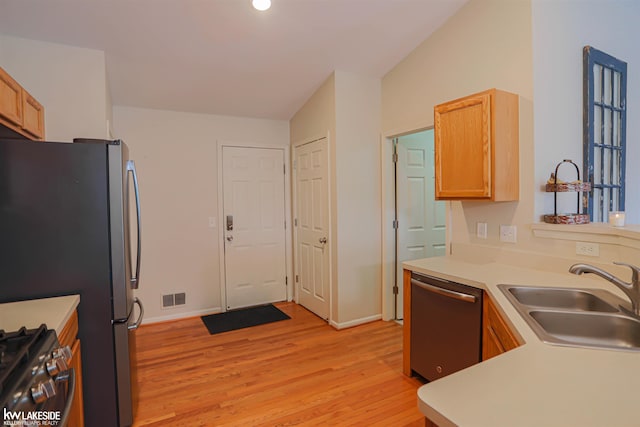 56798 Winding Creek Dr, Macomb, MI 48042 - kitchen featuring stainless steel appliances, light wood finished floors, light countertops, and light brown cabinetry